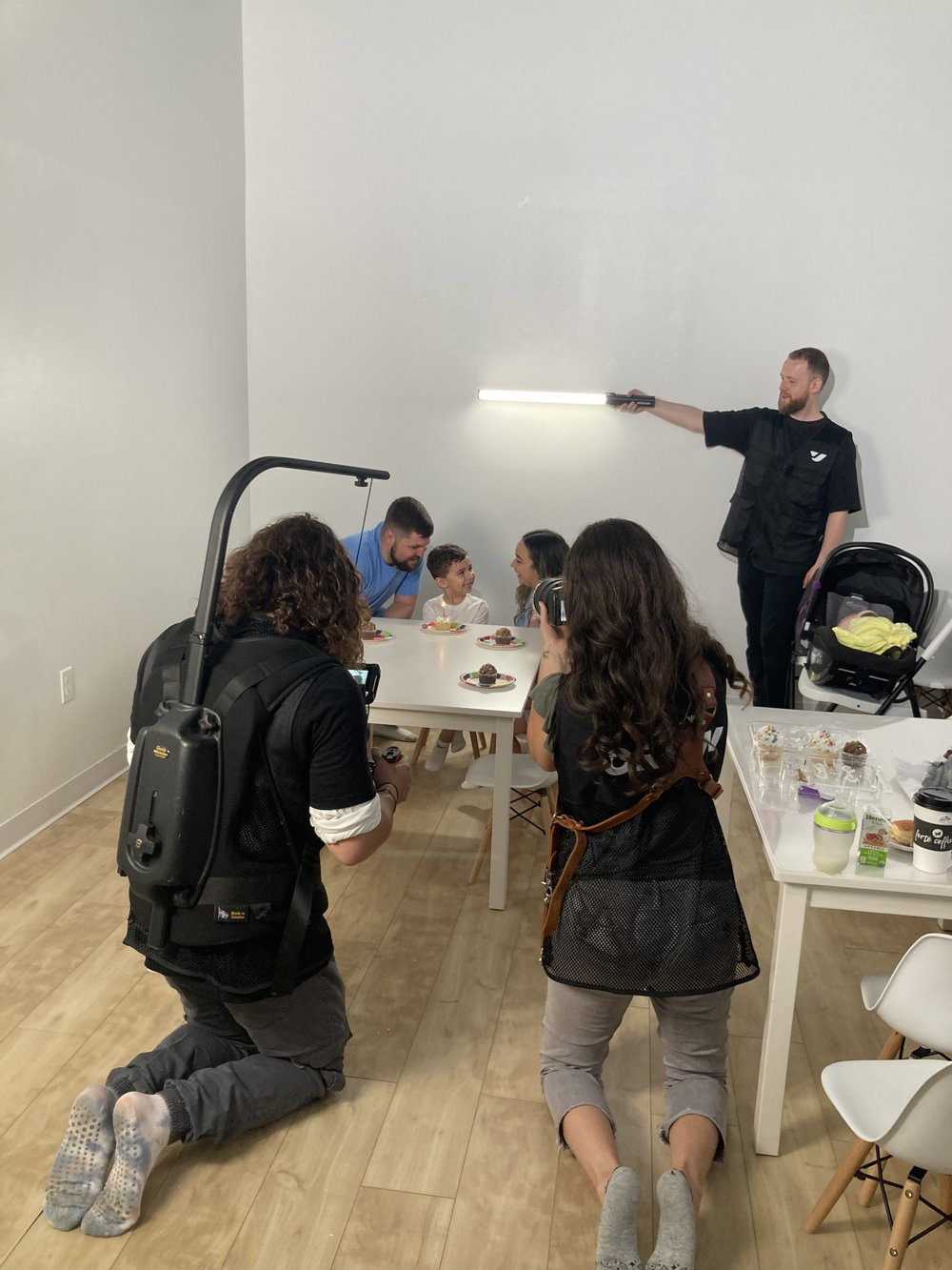 Behind the scenes: crew filming a family at a birthday table