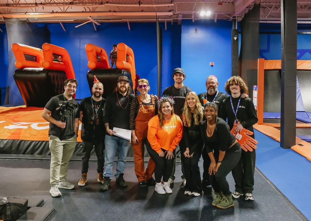 Behind the scenes: production crew and talent group photo on a Sky Zone set