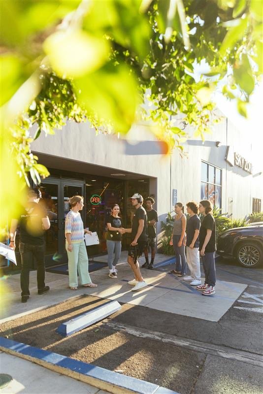 Behind the scenes: talent and crew lineup outside a Sky Zone park